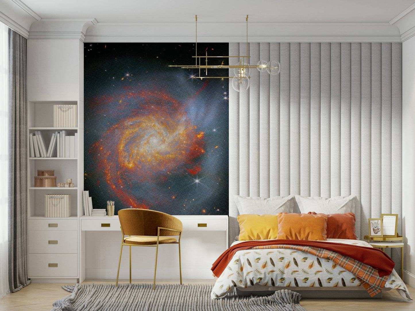 Stellar Canvas wallpaper mural showing a galaxy over a study desk and bed with orange pillows in a bedroom