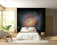 Stellar Canvas wallpaper mural showing a galaxy above a white-bedded wood-panel bedroom with a leather chair