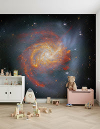 Stellar Canvas wallpaper mural with a fiery spiral galaxy in a nursery with a teddy bear and pink toy chest
