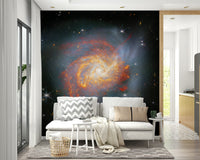 Stellar Canvas wallpaper mural of a deep-space galaxy behind a white loveseat sofa near an open kitchen