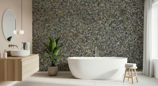 Stone aggregate texture wallpaper mural in a bathroom with a white freestanding tub and wooden vanity