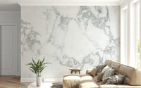 Stone Effect wallpaper mural in white and grey marble behind a beige sectional sofa in a bright living room