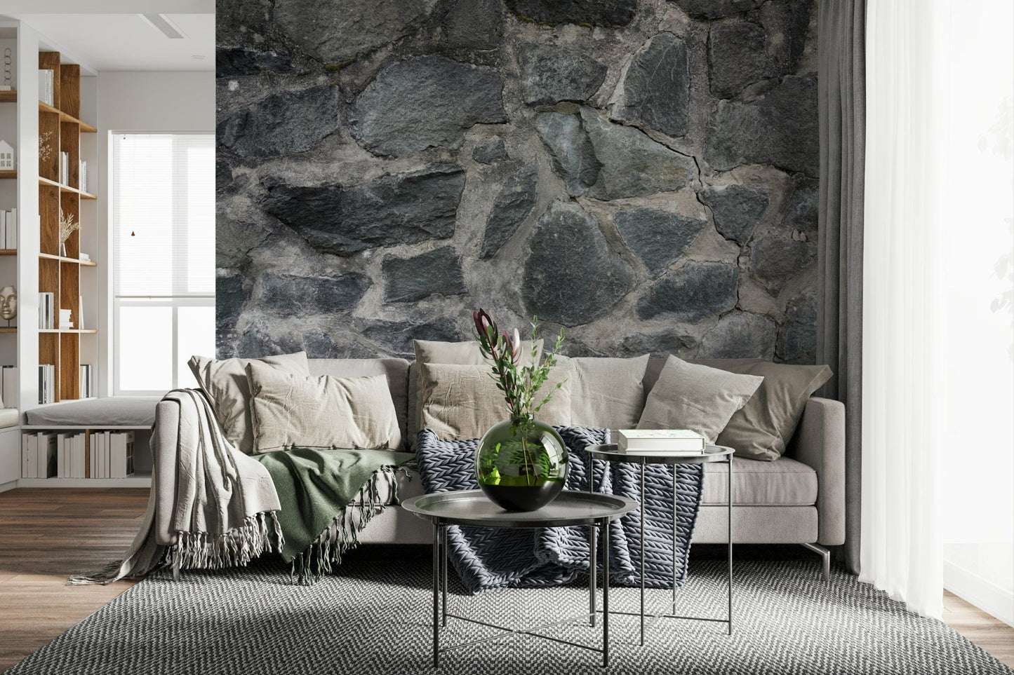 Stone Facade wallpaper mural behind a cream sectional with a green throw and round metal nesting tables