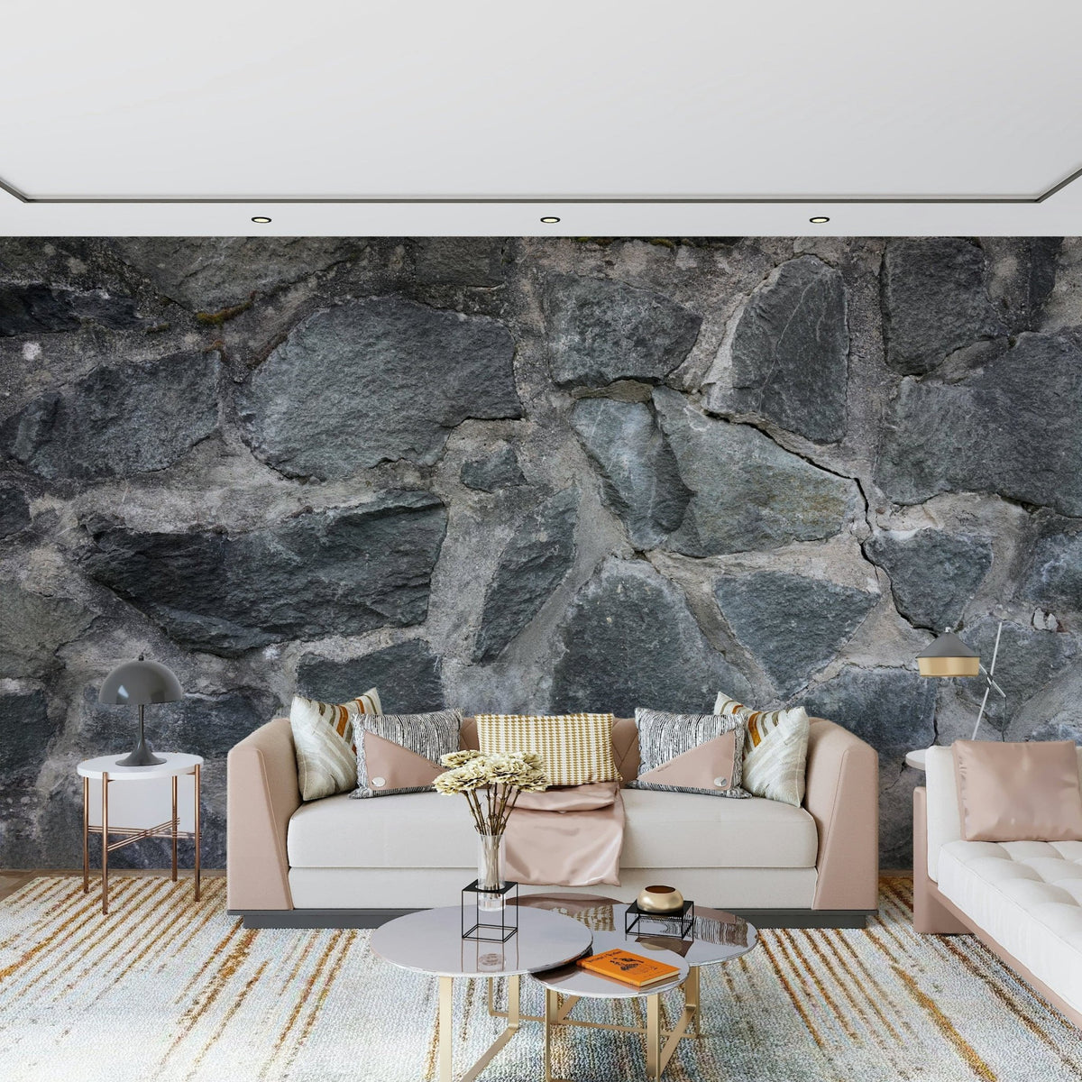 Stone Facade wallpaper mural behind a blush sofa with pink pillows and gold-framed round tables
