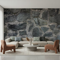 Stone Facade wallpaper mural behind a cream sectional with two rust chairs and a round white coffee table