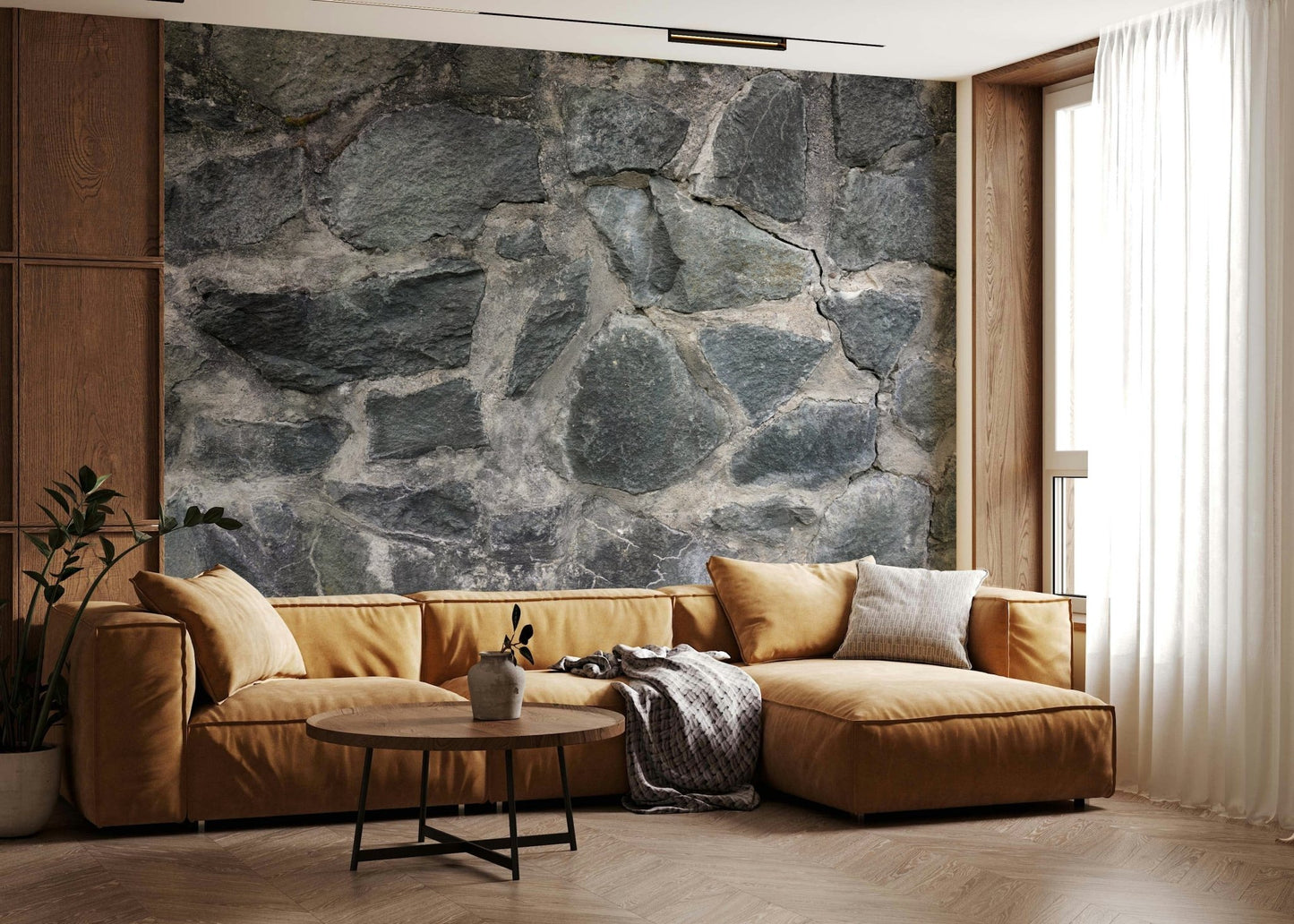 Stone Facade wallpaper mural behind a mustard leather sectional and round wood table by a wood-panel wall