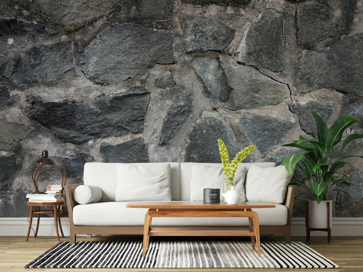 Stone Facade wallpaper mural behind a white sofa with a wood coffee table, banana plant and vintage chair