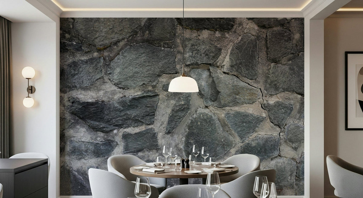 Stone Facade wallpaper mural behind a round dining table and grey chairs lit by a dome pendant