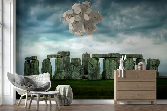 Stonehenge Majesty wallpaper mural of the ancient stone circle under a stormy sky behind a woven chair and wood dresser