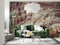 Striated Rock Face wallpaper mural of red rock strata behind a green velvet sofa and feather pendant