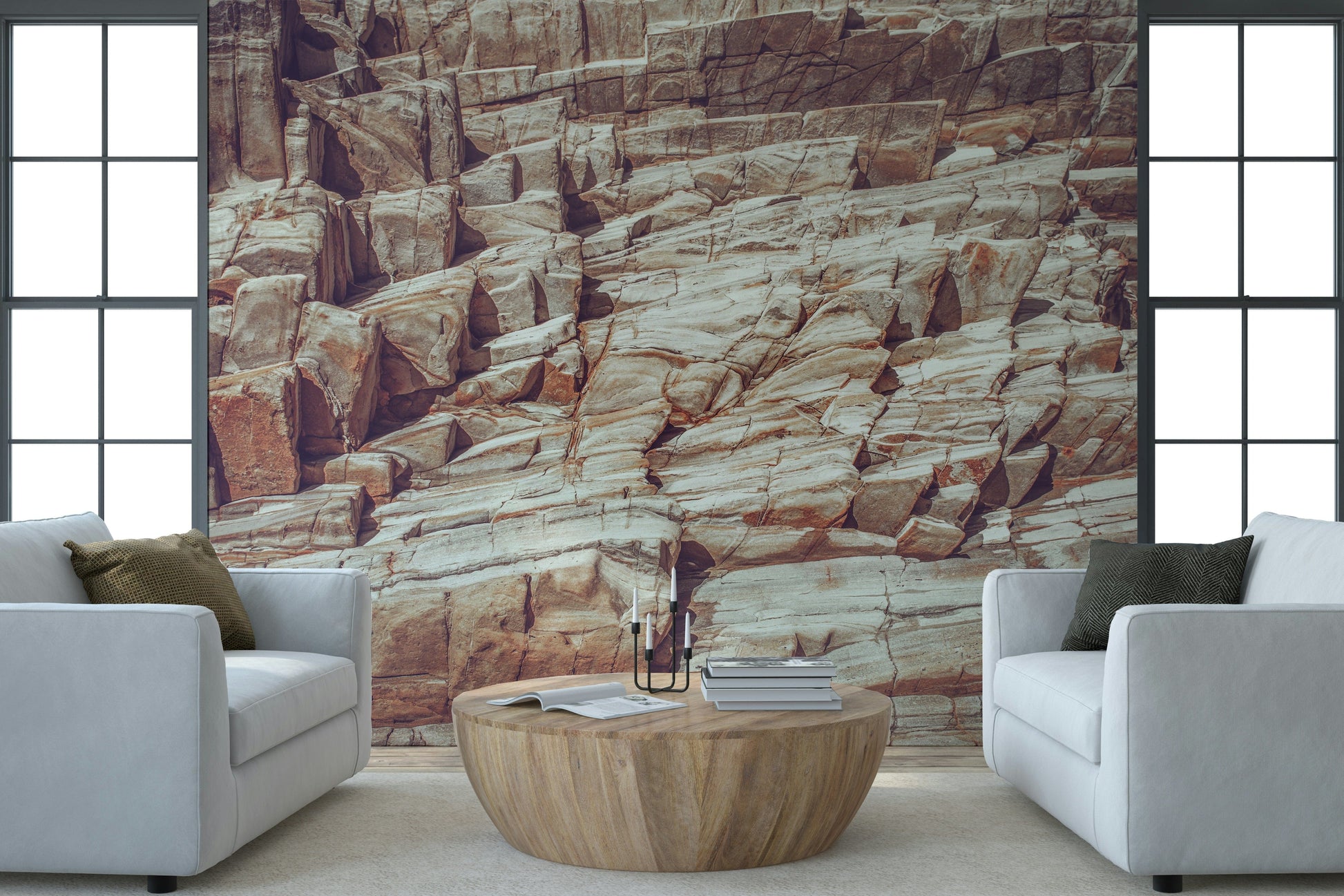 Striated Rock Face wallpaper mural of banded stone between two white armchairs and a round wood coffee table