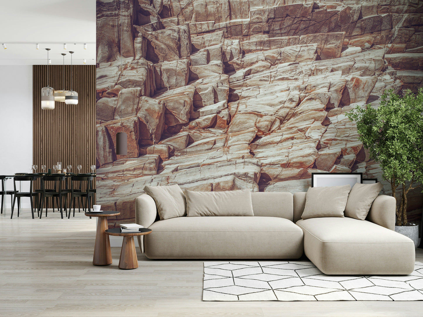Striated Rock Face wallpaper mural of layered red and cream stone behind a beige sectional sofa in a living room