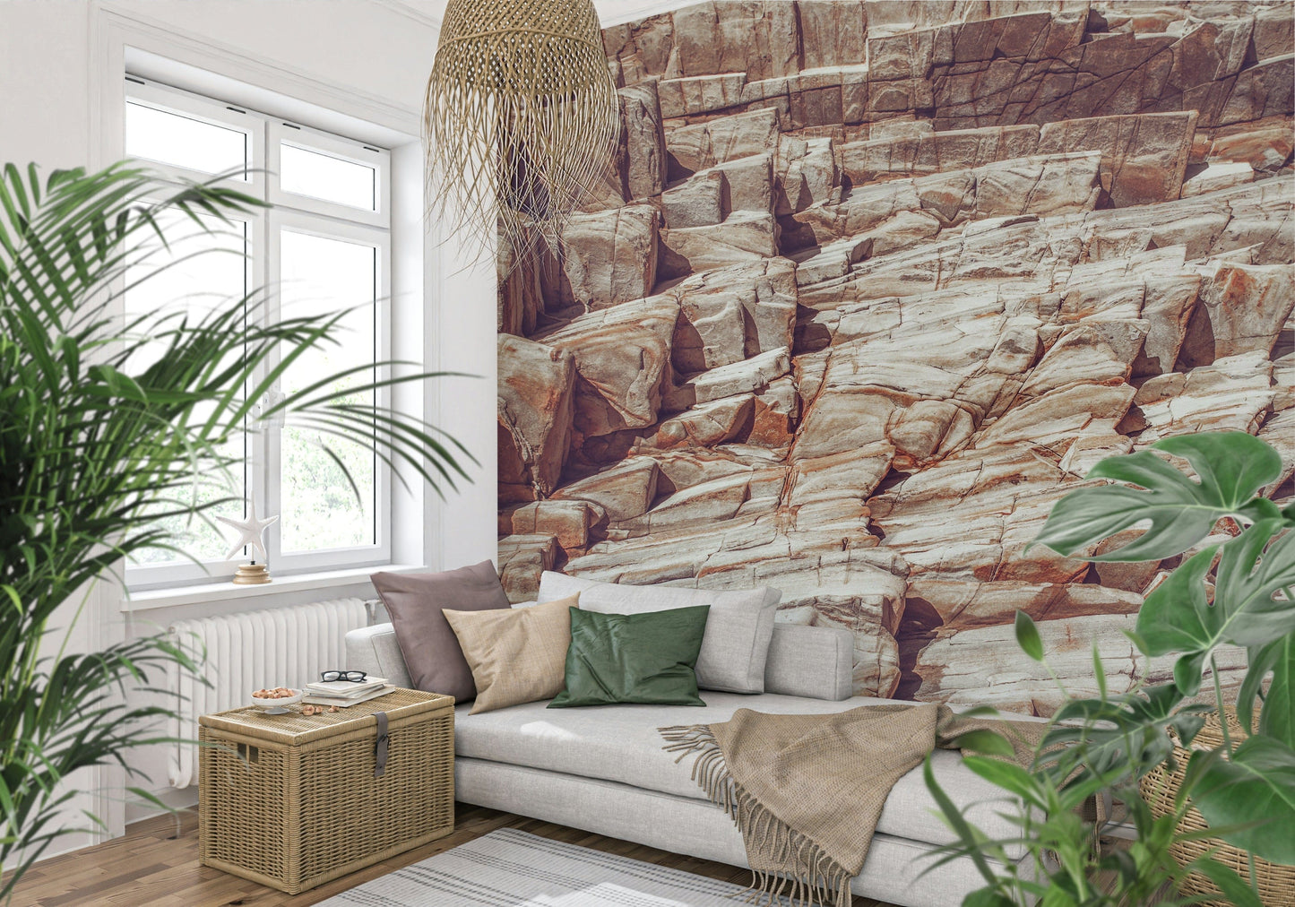 Striated Rock Face wallpaper mural of reddish rock strata behind a grey sofa with green cushions by a window