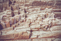 Striated Rock Face wallpaper mural shown as a full-wall close-up of layered red and cream banded stone