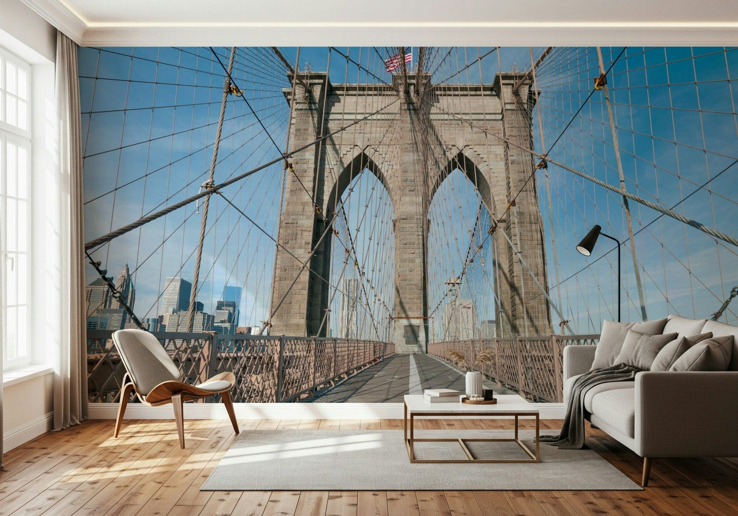 Strolling Across the Brooklyn Bridge wallpaper mural in a living room with a white sofa, wood chair and gold table