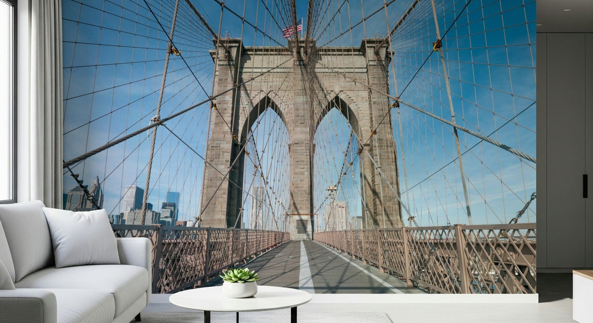 Strolling Across the Brooklyn Bridge wallpaper mural of the stone arch and cables in a living room with a white sofa