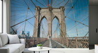 Strolling Across the Brooklyn Bridge wallpaper mural of the stone arch and cables in a living room with a white sofa