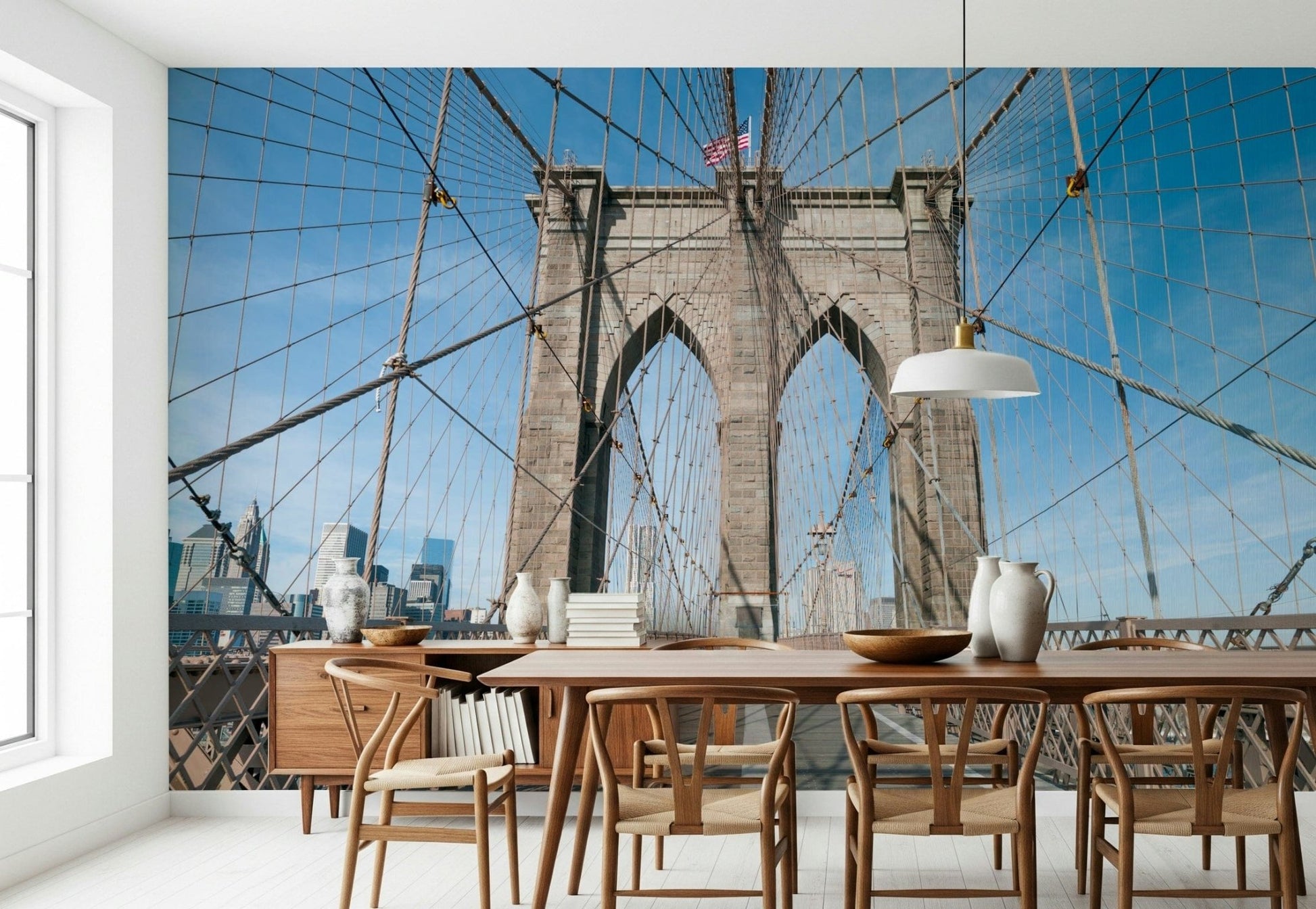 Strolling Across the Brooklyn Bridge wallpaper mural in a dining room with a wood table and woven wishbone chairs