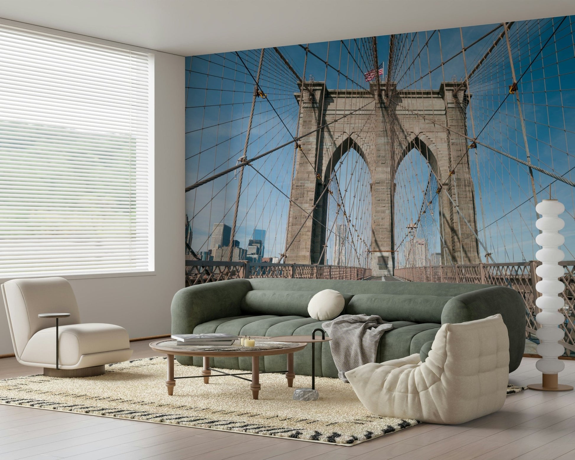 Strolling Across the Brooklyn Bridge wallpaper mural behind a sage green sofa and cream lounge chair in a living room