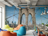 Strolling Across the Brooklyn Bridge wallpaper mural in a bright office lounge with colorful bean bags and laptop desks