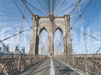 Strolling Across the Brooklyn Bridge wallpaper mural shown as a full-wall render of the walkway, stone tower and US flag