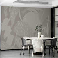 Subtle Foliage Reverie wallpaper mural with tonal greige leaves and dotted shapes in a dining room with round white table