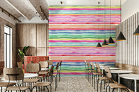 Wallpaper with multi-colored stripes in coral, turquoise, and soft pastels.

