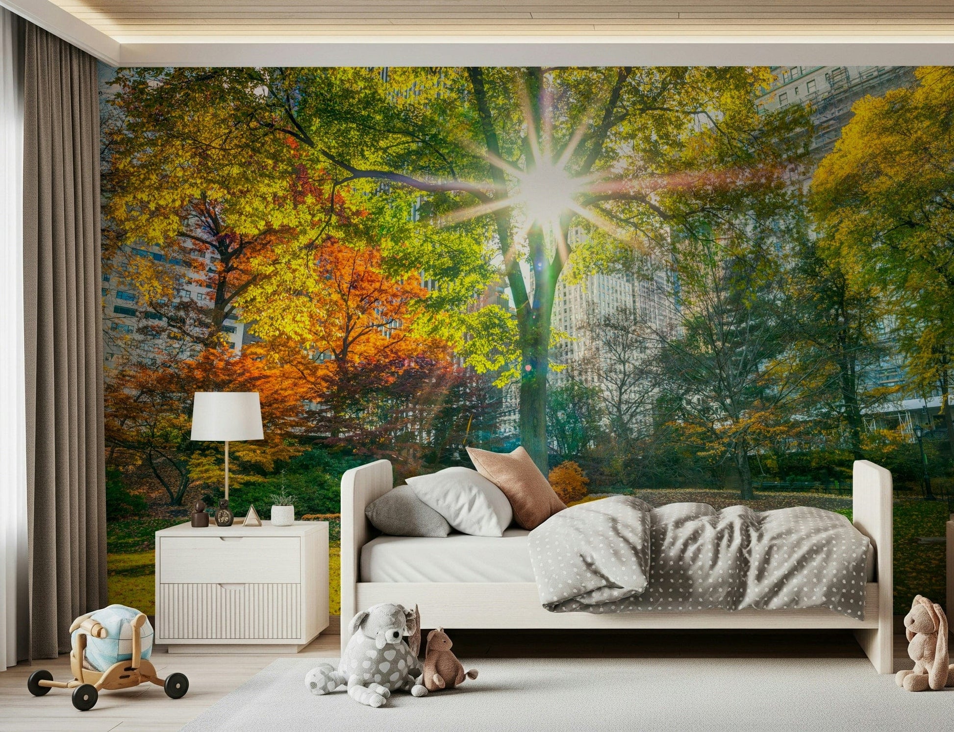 Sun Rays Through Trees wallpaper mural of sun beams through fall foliage behind a white kids bed with toys in a nursery
