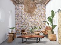 Delicate scattered flowers and leafy motifs creating a sunny, uplifting wallpaper pattern.