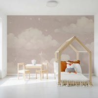 Sweet Dreams Blush wallpaper mural of pink clouds and stars in a kids room with a wooden house-frame bed and fox plush