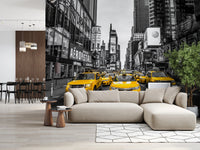 Taxi Rush Hour wallpaper mural of yellow taxis in monochrome New York behind a beige sectional in a living room