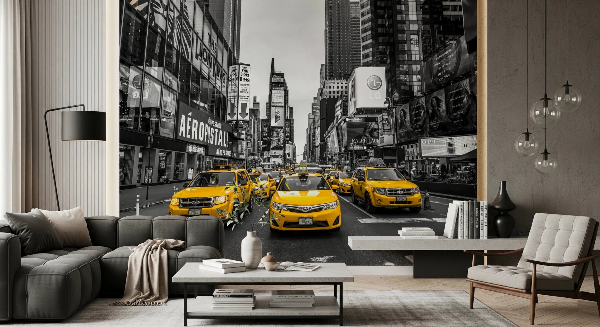 Taxi Rush Hour wallpaper mural of yellow cabs in Times Square behind a grey sofa and cream armchair in a living room