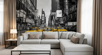 Taxi Rush Hour wallpaper mural of yellow taxis in New York behind a grey L-shaped sectional in a living room
