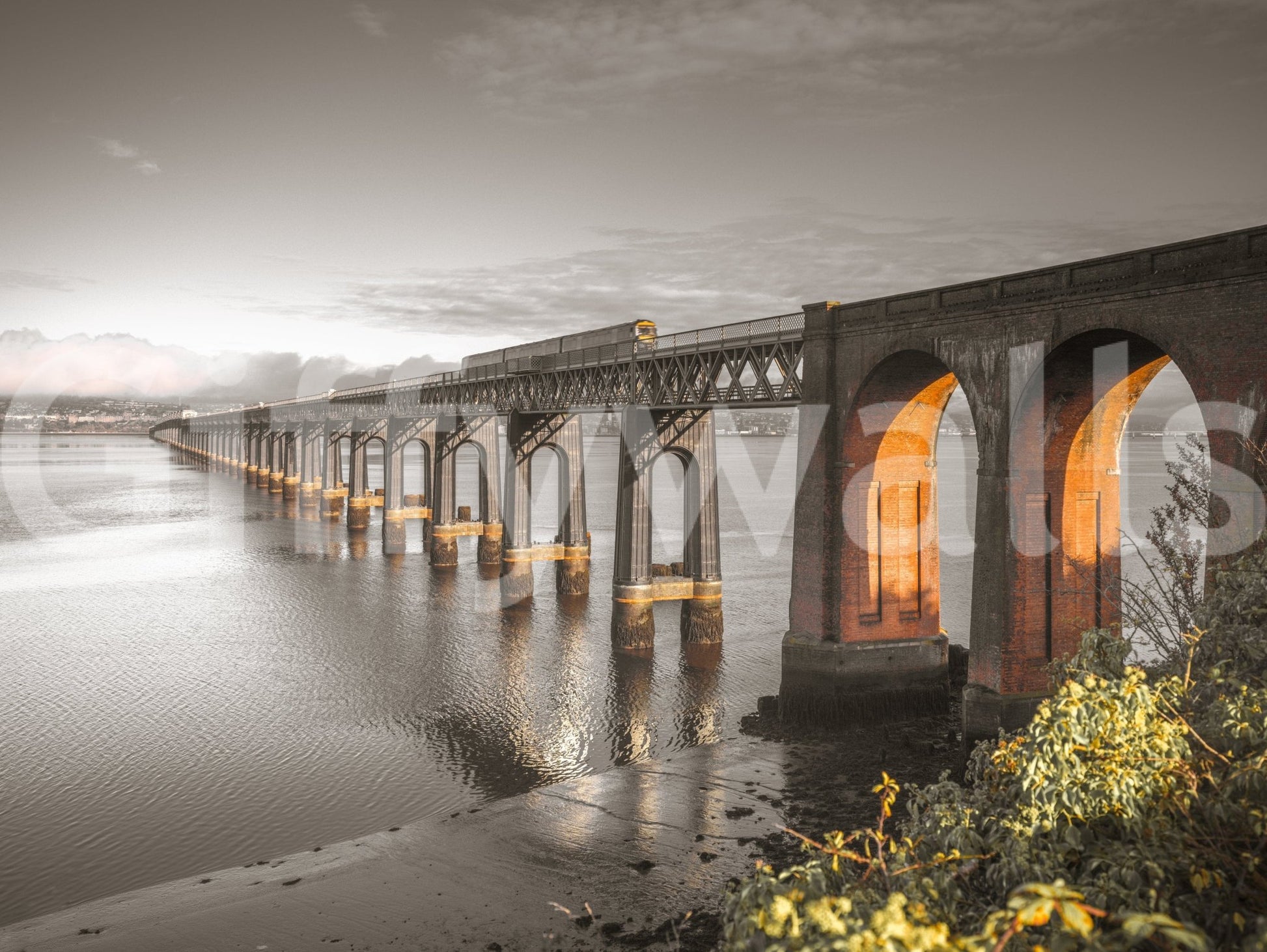 Tay Rail Bridge shown as a full-wall mural, sepia photo of the bridge with brick arches glowing orange over water