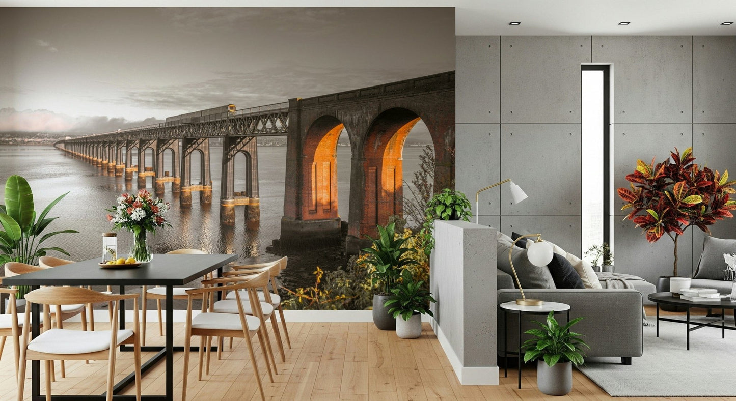 Tay Rail Bridge wallpaper mural beside a grey sofa and black dining table in a concrete-walled living room
