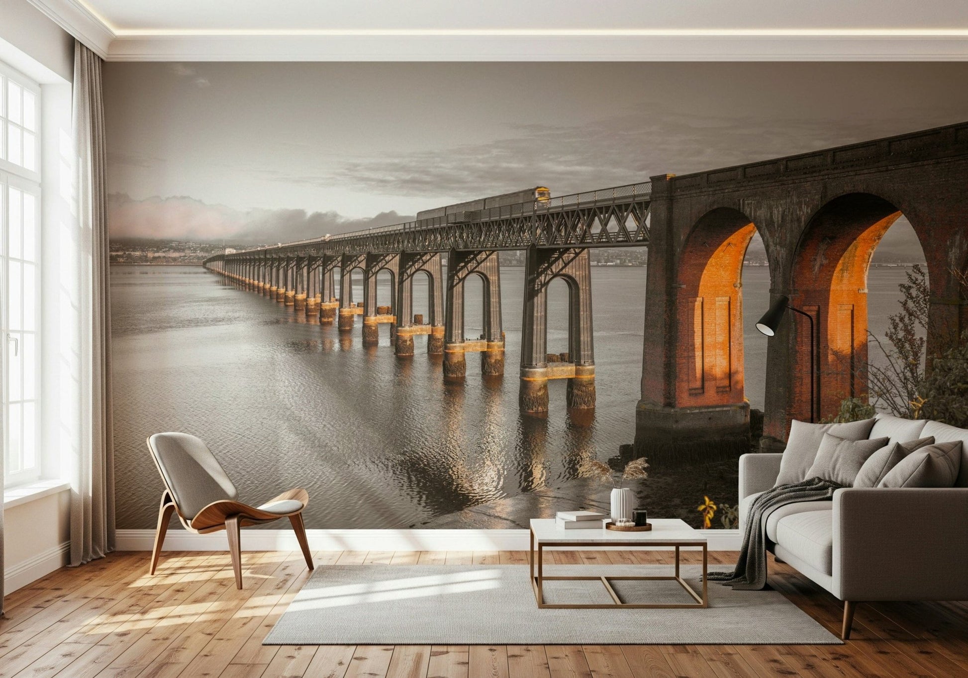 Tay Rail Bridge wallpaper mural in sepia behind a grey sofa and shell lounge chair in a living room