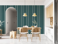 Teal Stripe wallpaper with cream pinstripes beside an arched doorway and wood dining table under yellow pendant lights
