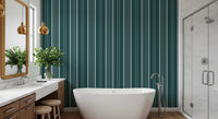 Teal Stripe wallpaper with cream vertical lines behind a freestanding tub and marble vanity in a bright bathroom