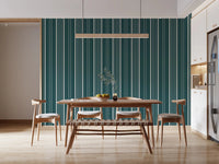 Teal Stripe wallpaper with cream vertical pinstripes behind a wood dining table, chairs and bench in a bright kitchen-diner