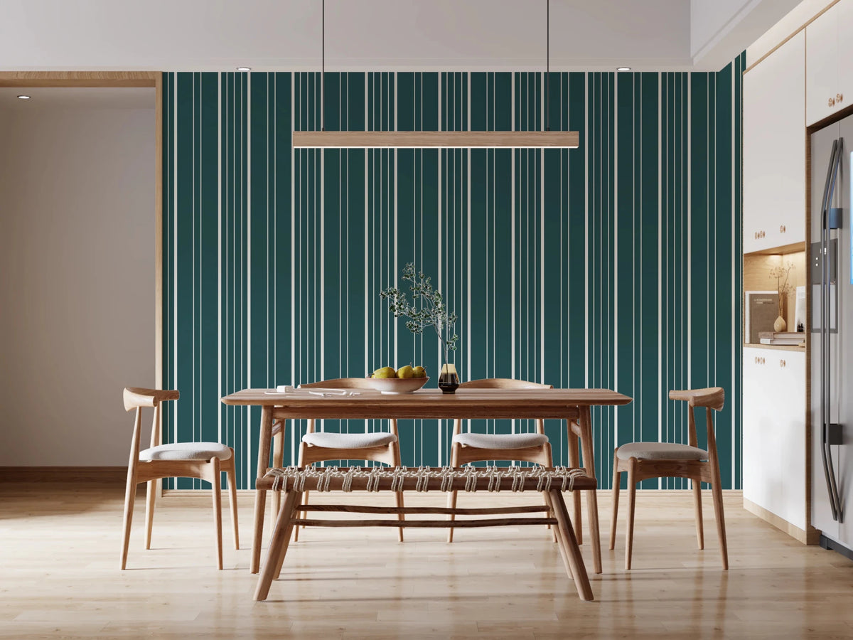 Teal Stripe wallpaper with cream vertical pinstripes behind a wood dining table, chairs and bench in a bright kitchen-diner