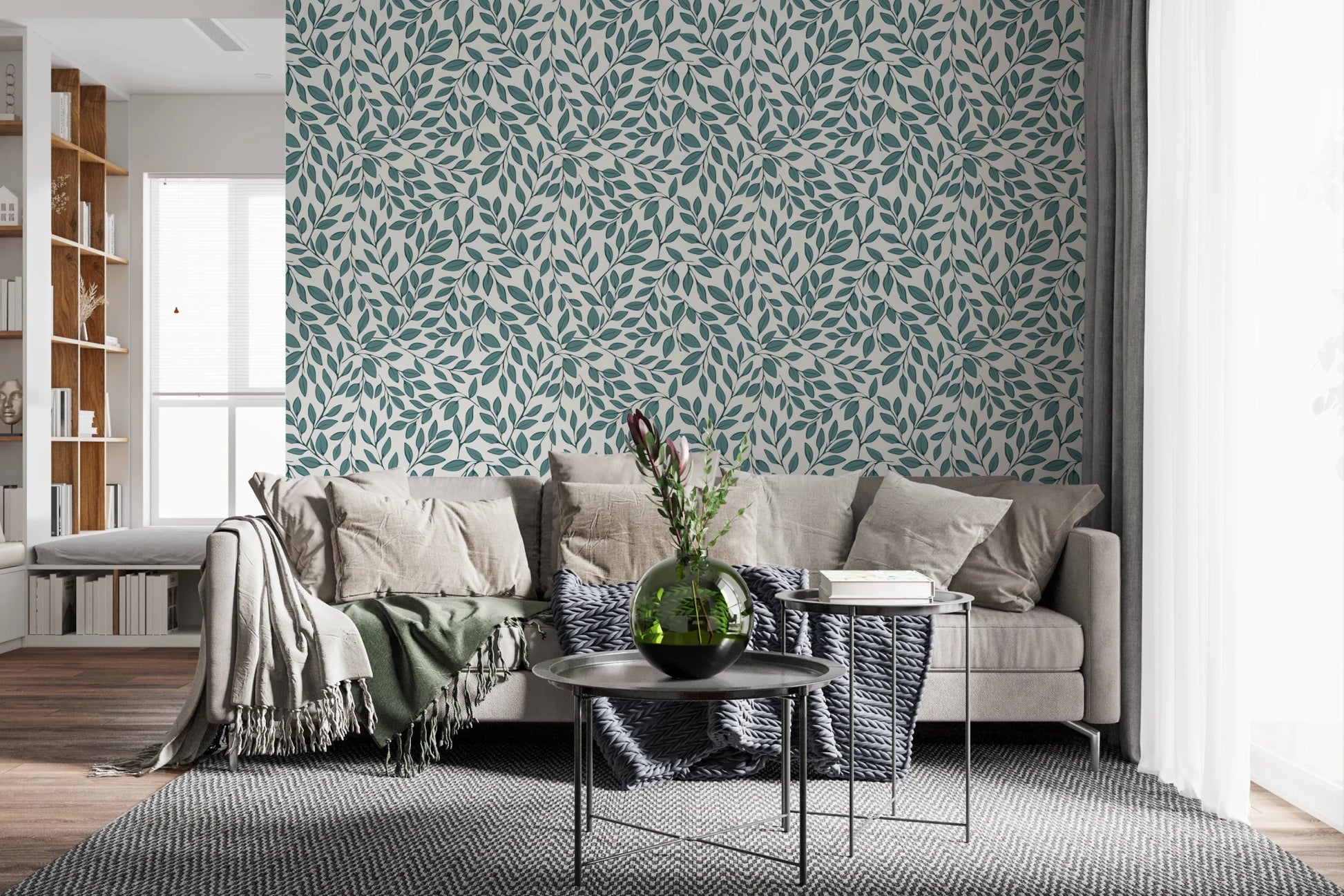 Teal Vines wallpaper of teal leaves behind a beige sectional sofa with knit throws and metal side tables