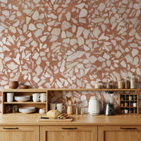 Stone terrazzo wall mural. Earthy red-orange fragment appearance.