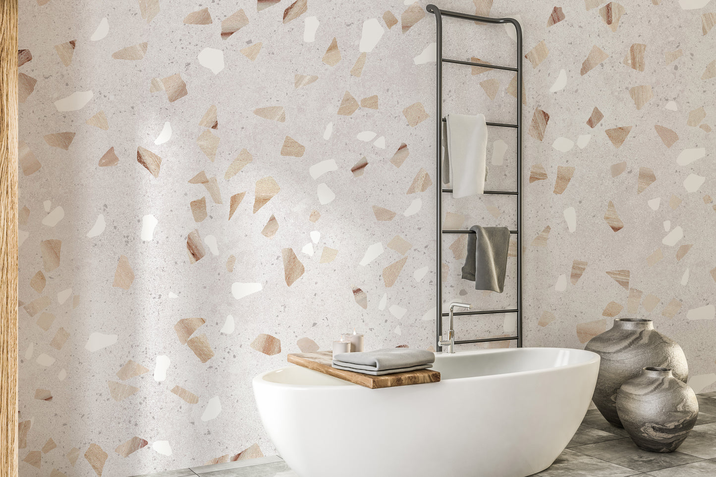 Terrazzo Marble Tile wallpaper mural with tan and white chips behind a white bathtub and black towel ladder