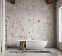 Terrazzo Marble Tile wallpaper mural in cream with beige and white chips behind a white freestanding bathtub