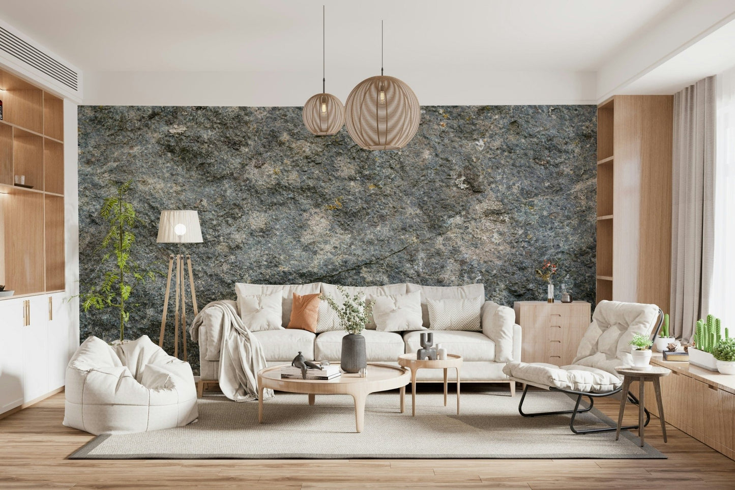 Textured Rock wallpaper mural in grey stone behind a cream sofa with woven pendants and built-in shelving