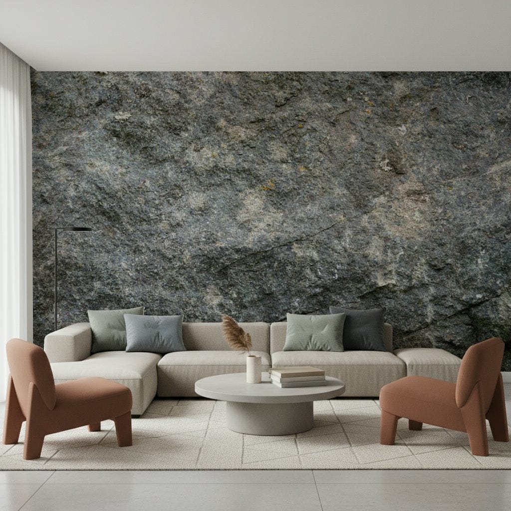 Textured Rock wallpaper mural in grey stone behind a beige sectional sofa and two terracotta armchairs