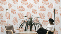 Textured watercolor palm leaf wallpaper in terracotta

