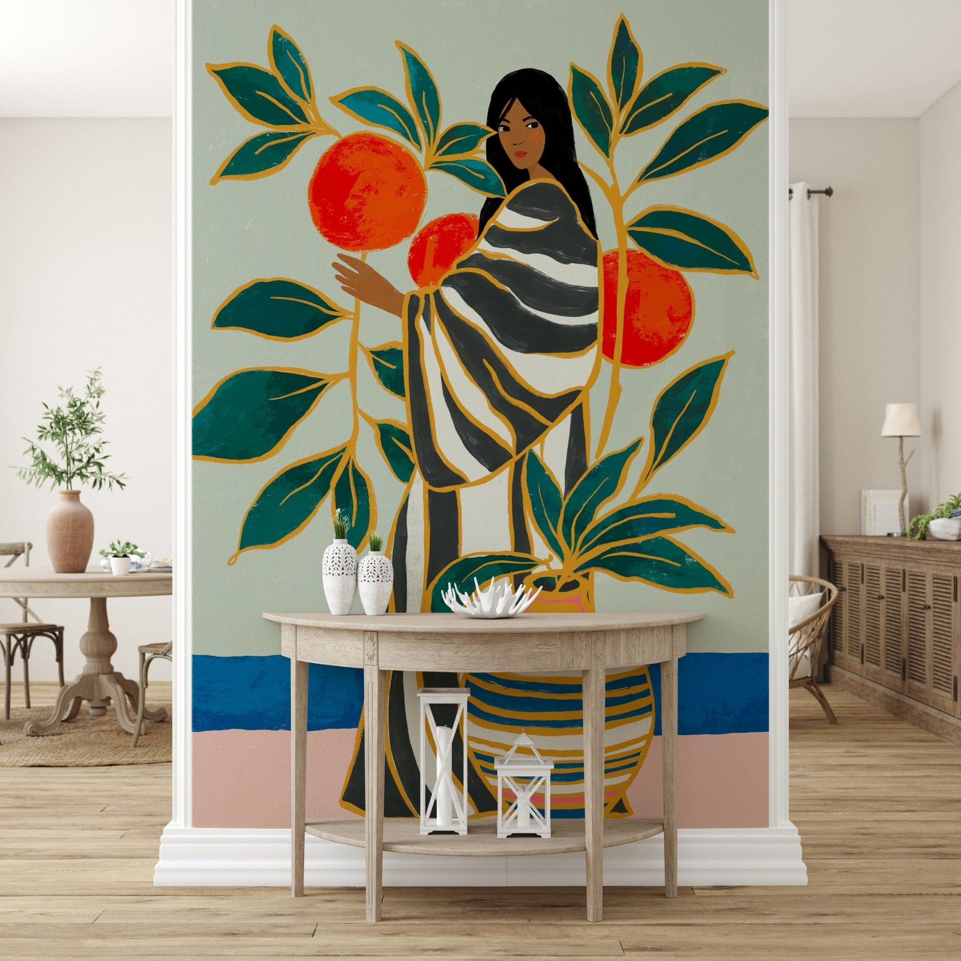 The Keeper of Oranges wallpaper mural with a woman and oranges above a half-moon wood console in an entryway