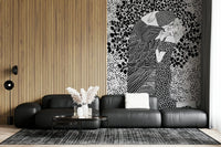 The Kiss II wallpaper mural of an embracing couple beside wood slats above a black leather modular sofa