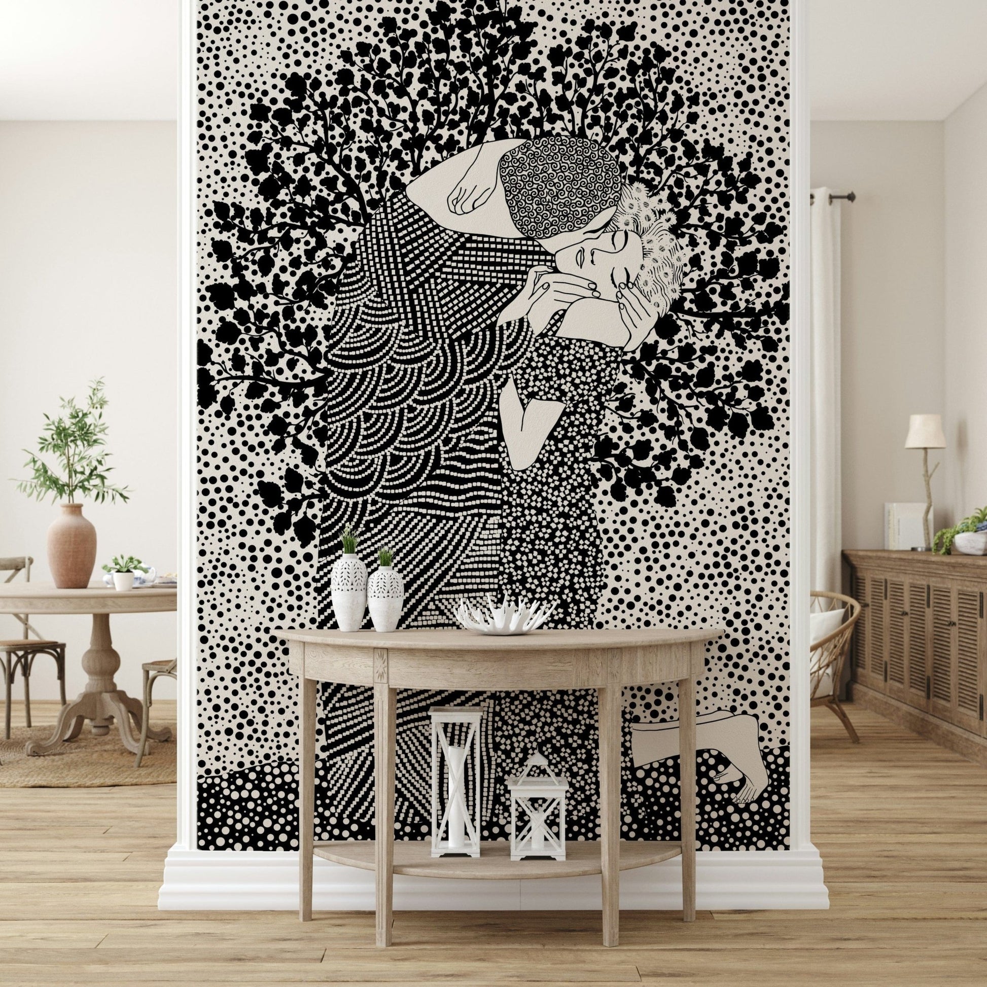 The Kiss II wallpaper mural of an embracing couple in black and white behind a wood demilune console table